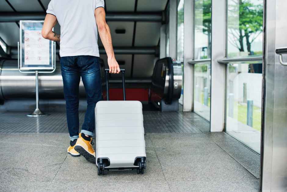 person pulling travel luggage